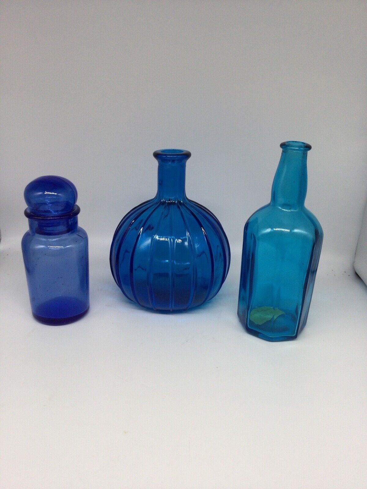 Three Blue Glass Decorative Bottles