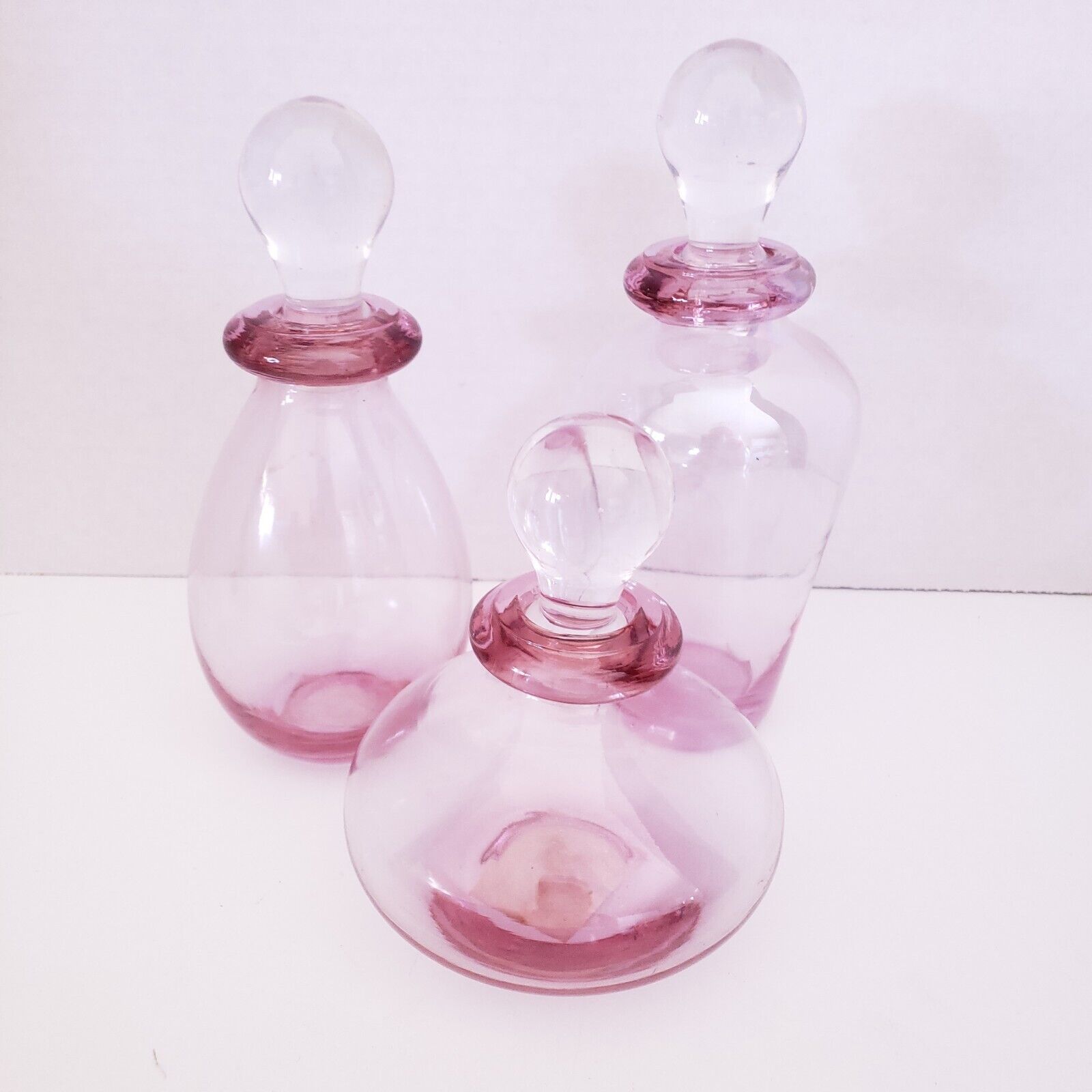 Set Of 3 Glass Bottles W/ Stoppers Clear Cranberry Pink Iridescent Three Hands